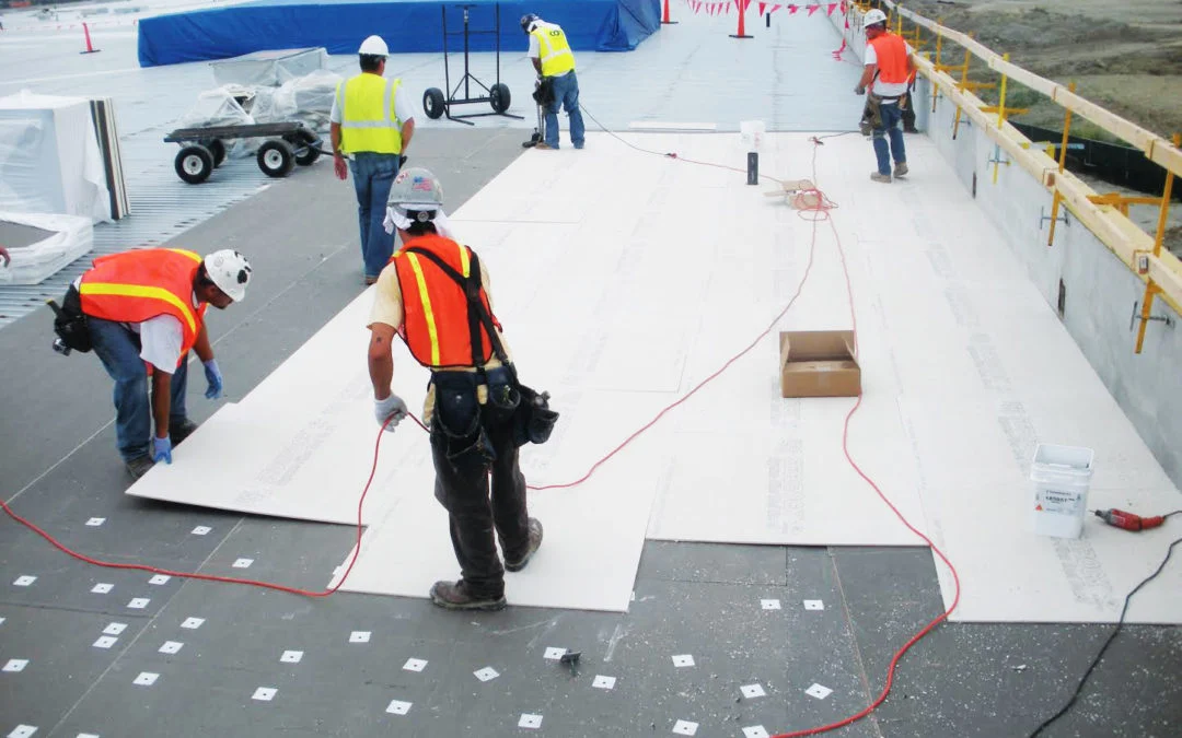 Commercial roofing contractor repairing industrial flat roof
